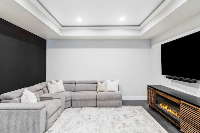 6037 N Netherland Ct, Aurora, CO 80019 - living room with a raised ceiling, concrete floors, recessed lighting, baseboards, and a glass covered fireplace