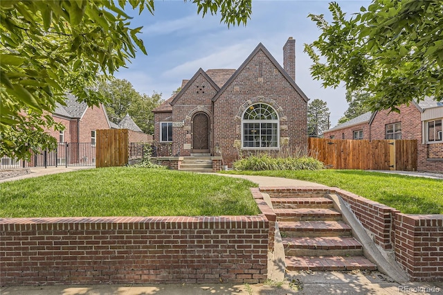 english style home featuring a front lawn