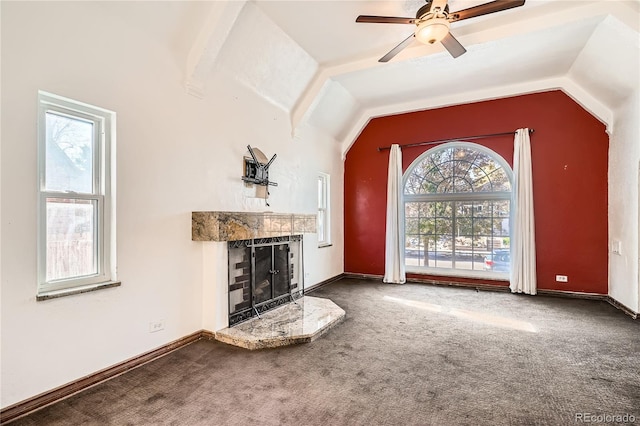 unfurnished living room with carpet, plenty of natural light, and lofted ceiling