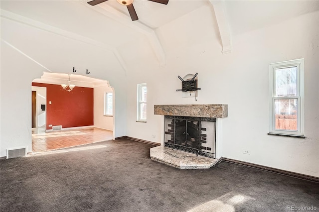 unfurnished living room with carpet, lofted ceiling with beams, and ceiling fan