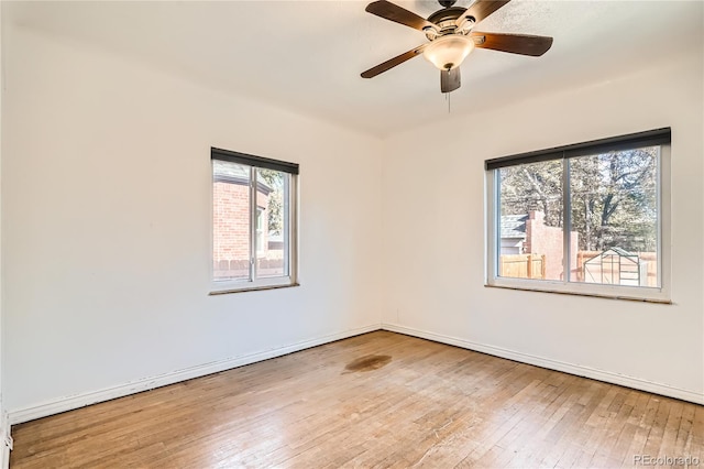 unfurnished room with light wood-type flooring and ceiling fan