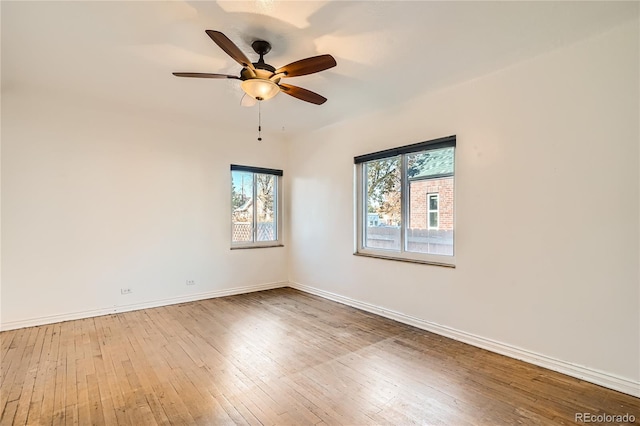 spare room featuring ceiling fan and hardwood / wood-style flooring