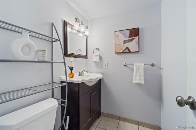 bathroom with tile patterned flooring, vanity, and toilet