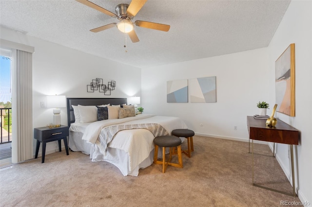 carpeted bedroom featuring access to outside, ceiling fan, and a textured ceiling