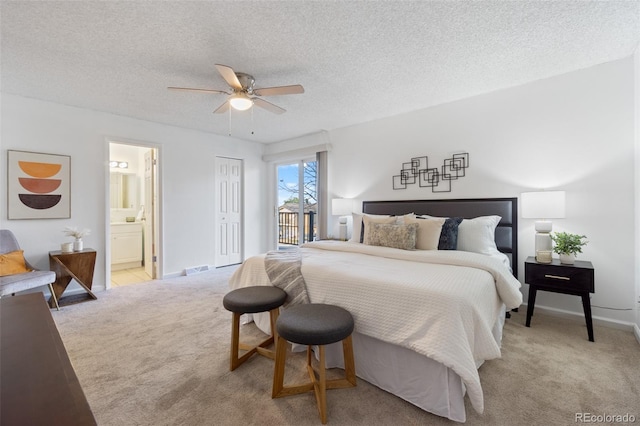 bedroom with ensuite bath, ceiling fan, light carpet, and a textured ceiling