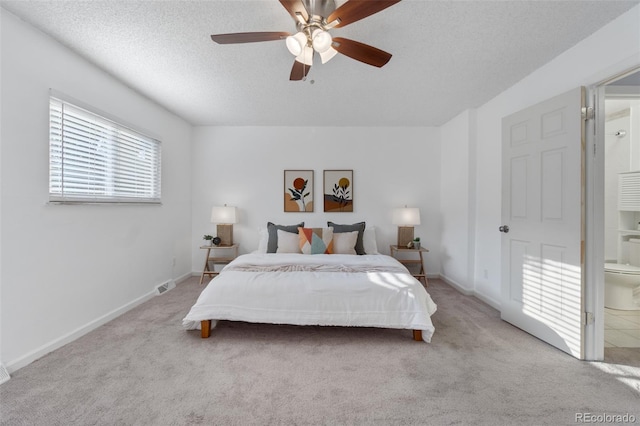 carpeted bedroom featuring ceiling fan, a textured ceiling, and connected bathroom