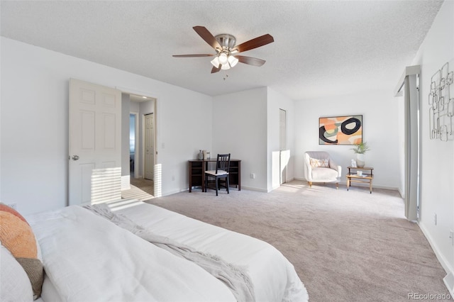 carpeted bedroom with ceiling fan and a textured ceiling