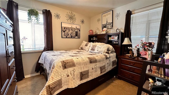 carpeted bedroom with multiple windows