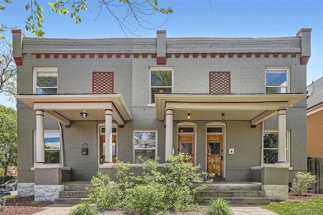 2564 N Emerson St, Denver, CO 80205 - view of front of house with a porch and brick siding