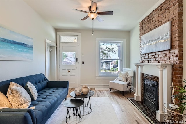 2564 N Emerson St, Denver, CO 80205 - living area with wood finished floors, a fireplace, ceiling fan, and baseboards