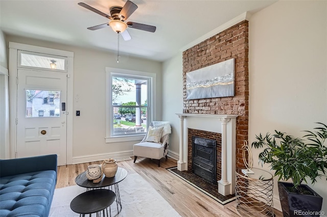 2564 N Emerson St, Denver, CO 80205 - living area with ceiling fan, light wood-style flooring, a fireplace, and baseboards