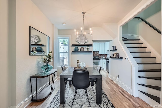 2564 N Emerson St, Denver, CO 80205 - dining space featuring stairway, a chandelier, light wood finished floors, and baseboards