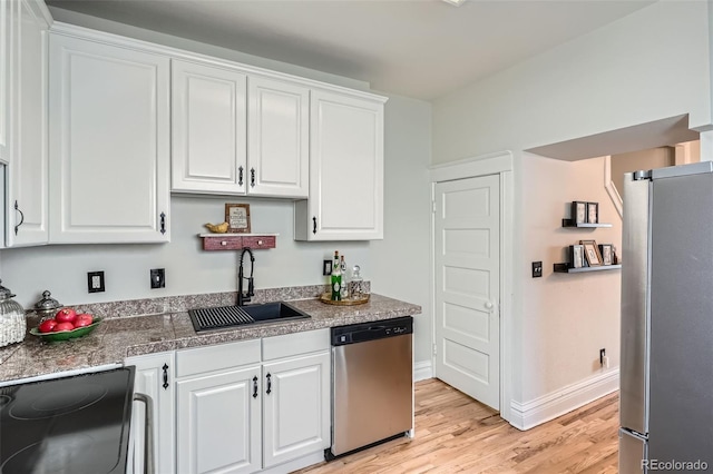 2564 N Emerson St, Denver, CO 80205 - kitchen featuring stainless steel appliances, a sink, white cabinetry, light wood-type flooring, and baseboards