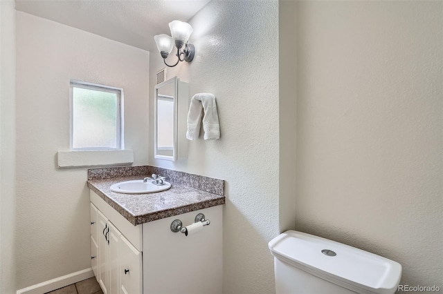 2564 N Emerson St, Denver, CO 80205 - half bath with vanity, toilet, and tile patterned flooring