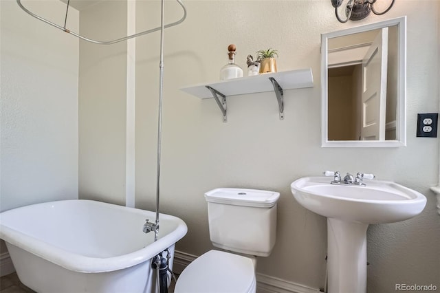2564 N Emerson St, Denver, CO 80205 - full bathroom featuring a freestanding bath, toilet, and a sink