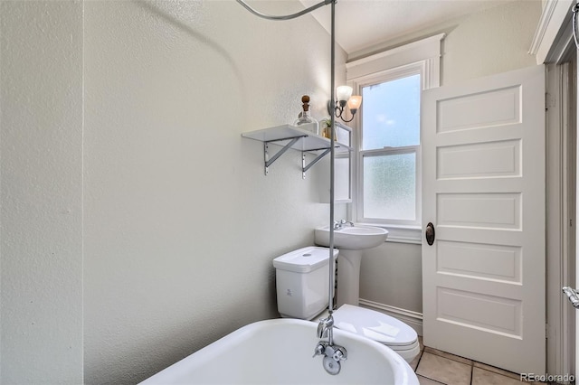 2564 N Emerson St, Denver, CO 80205 - bathroom with toilet, a soaking tub, and tile patterned floors