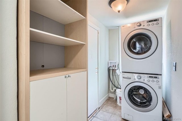 2564 N Emerson St, Denver, CO 80205 - clothes washing area featuring stacked washing machine and dryer and light tile patterned flooring
