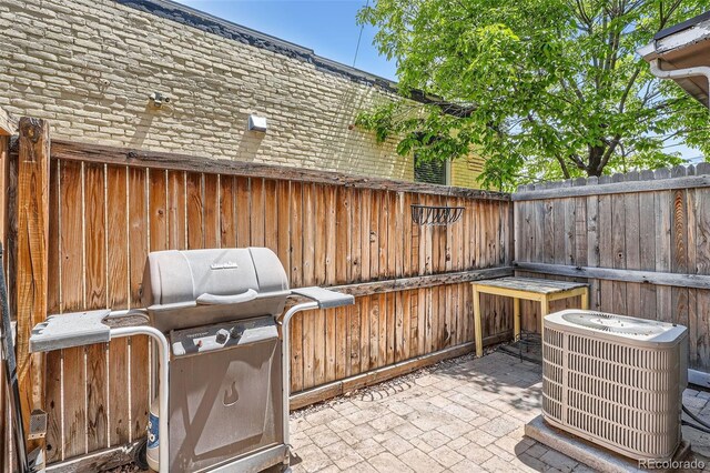 2564 N Emerson St, Denver, CO 80205 - view of patio with central AC unit, a fenced backyard, and a grill