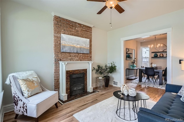 2564 N Emerson St, Denver, CO 80205 - living area with a ceiling fan, wood finished floors, a fireplace, and a chandelier