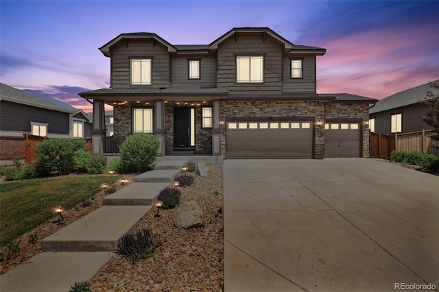 76 N Ider St, Aurora, CO 80018 - craftsman house featuring driveway, stone siding, and a garage