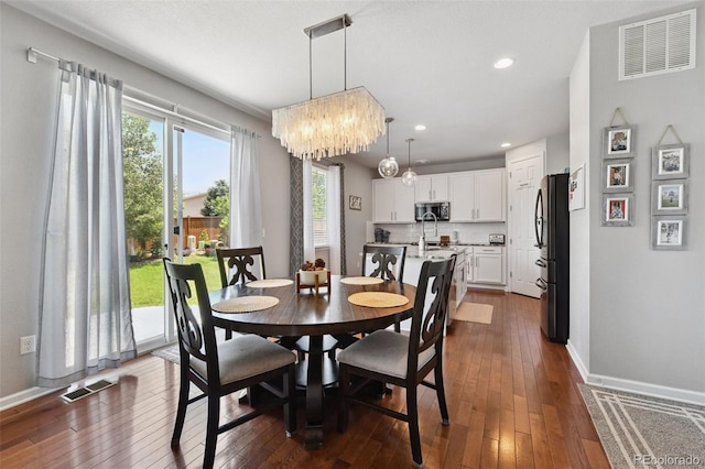 76 N Ider St, Aurora, CO 80018 - dining space featuring dark wood-style flooring, a chandelier, and recessed lighting