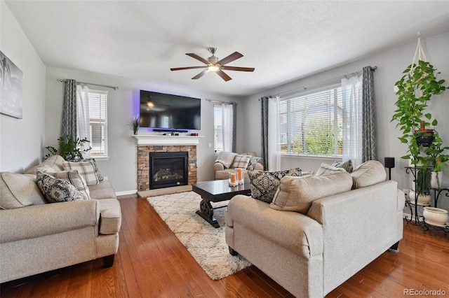76 N Ider St, Aurora, CO 80018 - living room featuring a ceiling fan, a fireplace, and wood-type flooring