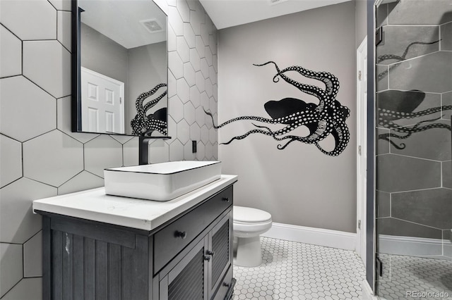 76 N Ider St, Aurora, CO 80018 - bathroom featuring a stall shower, vanity, tile patterned flooring, and tile walls