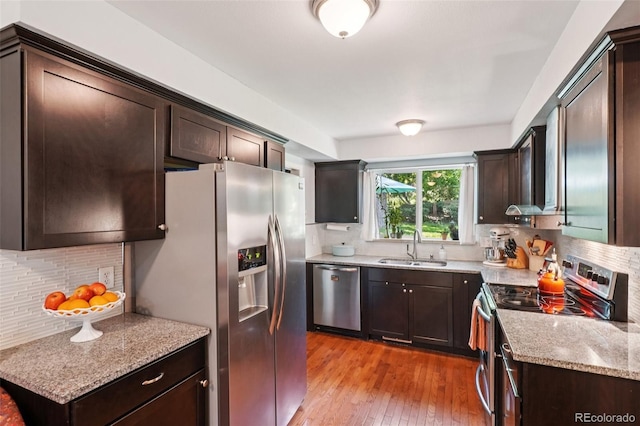 13140 W 15th Dr, Golden, CO 80401 - kitchen featuring appliances with stainless steel finishes, dark brown cabinets, and tasteful backsplash