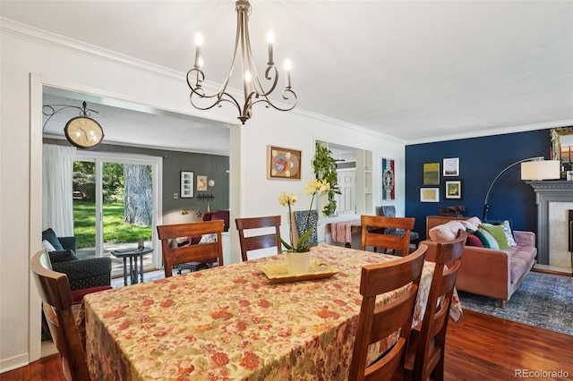 13140 W 15th Dr, Golden, CO 80401 - dining room featuring dark wood-style flooring, ornamental molding, a chandelier, and built in shelves