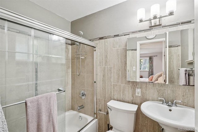 13140 W 15th Dr, Golden, CO 80401 - full bathroom featuring tile walls, shower / bath combination with glass door, and connected bathroom