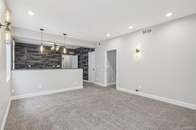 unfurnished living room featuring carpet flooring and ceiling fan