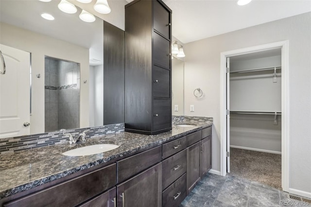 bathroom with decorative backsplash and vanity