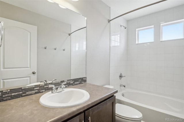 full bathroom with vanity, toilet, shower / bath combination, and backsplash