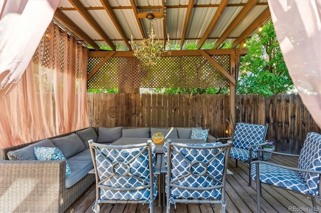 wooden deck with outdoor lounge area and fence