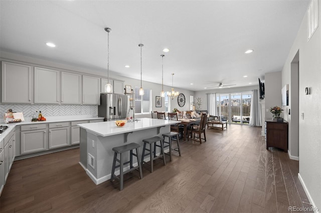 3575 White Rose Loop, Castle Rock, CO 80108 - kitchen with stainless steel fridge with ice dispenser, tasteful backsplash, gray cabinetry, dark wood-style floors, and recessed lighting