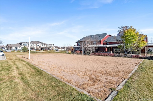 view of property's community with volleyball court and a lawn