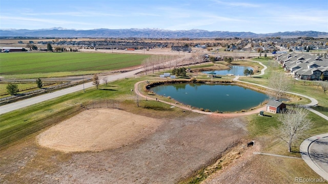 drone / aerial view featuring a water and mountain view