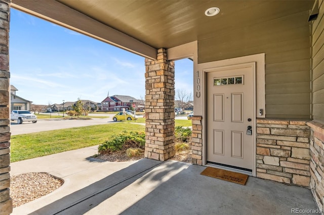 doorway to property with a yard