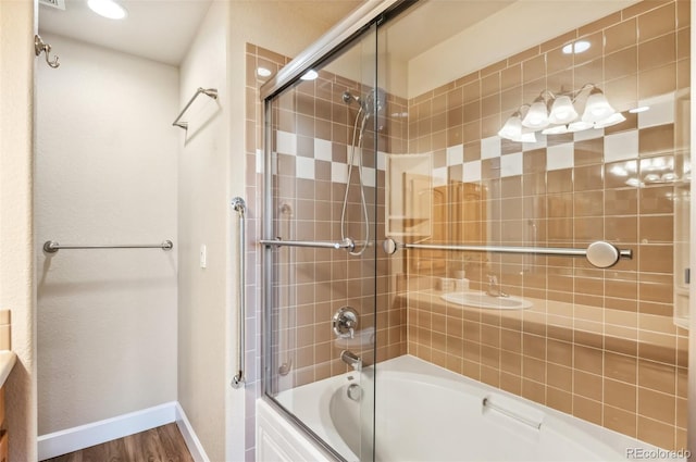 bathroom featuring combined bath / shower with glass door and hardwood / wood-style flooring