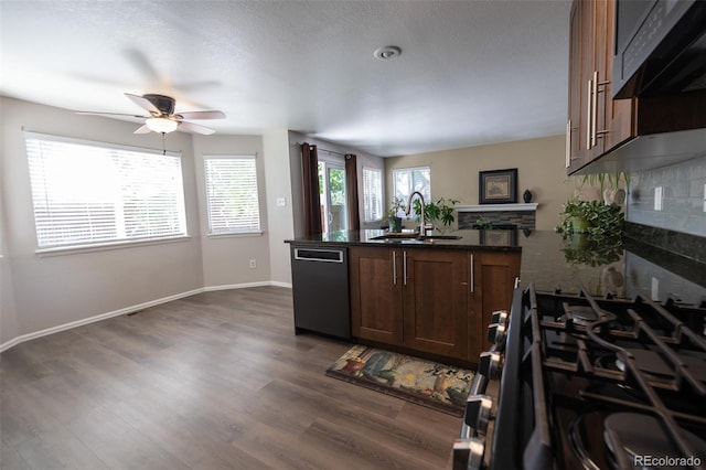 5630 W 115th Ave, Westminster, CO 80020 - kitchen with dishwashing machine, a peninsula, ceiling fan, dark wood finished floors, and range with gas cooktop