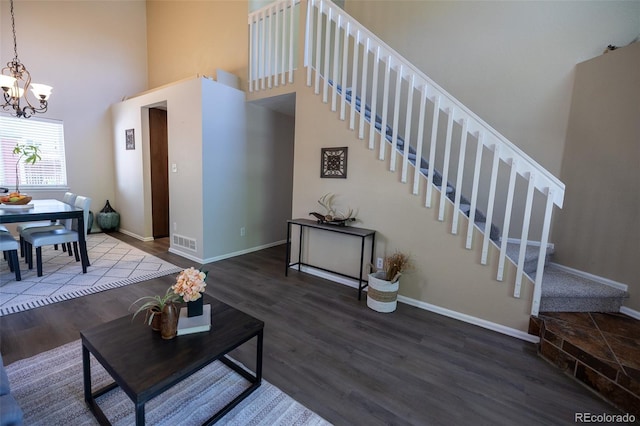 5630 W 115th Ave, Westminster, CO 80020 - living room with stairs, a towering ceiling, a chandelier, and wood finished floors