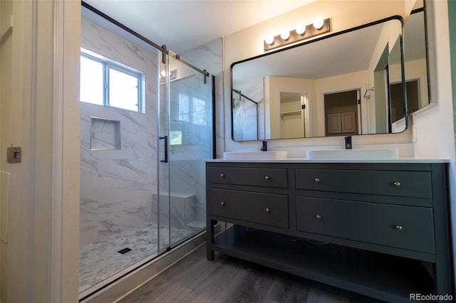 5630 W 115th Ave, Westminster, CO 80020 - bathroom with a marble finish shower, wood finished floors, and double vanity