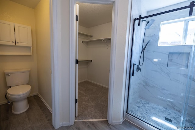 5630 W 115th Ave, Westminster, CO 80020 - bathroom with a marble finish shower, a spacious closet, and wood finished floors