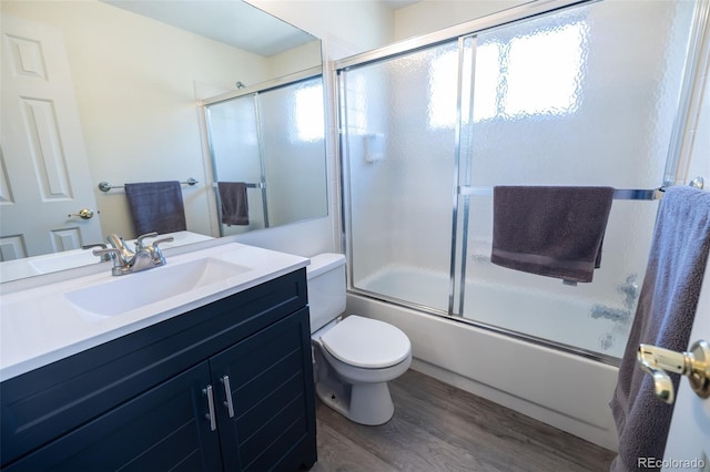 5630 W 115th Ave, Westminster, CO 80020 - bathroom featuring vanity, combined bath / shower with glass door, and wood finished floors