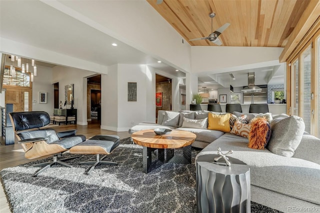 living area featuring wood ceiling, baseboards, a healthy amount of sunlight, and wood finished floors