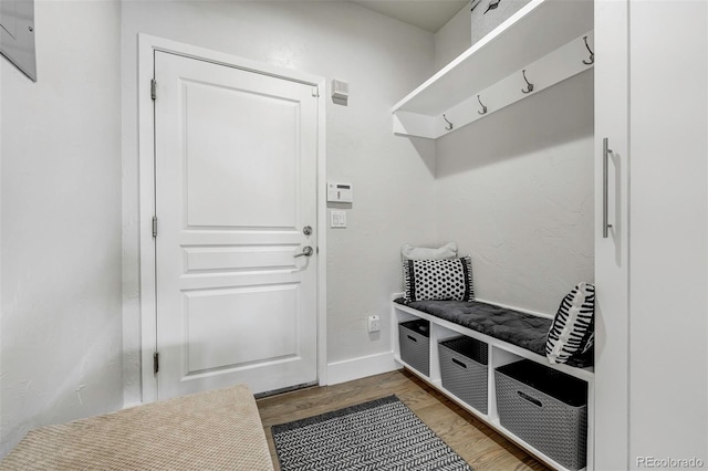 mudroom with wood finished floors and baseboards