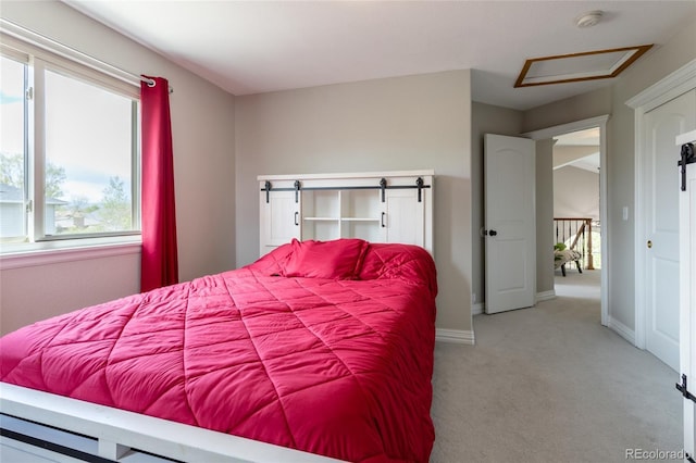 carpeted bedroom featuring baseboards, multiple windows, and attic access