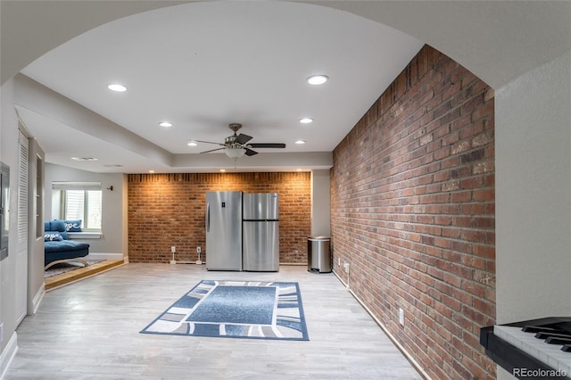 interior space with brick wall, baseboards, ceiling fan, recessed lighting, and light wood finished floors