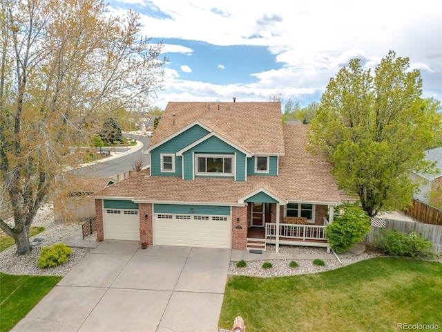view of front of property with roof with shingles, fence, brick siding, a porch, and driveway