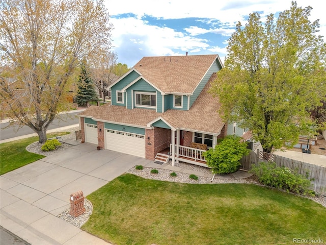 view of front of home with fence, a front yard, brick siding, a porch, and driveway
